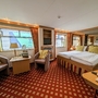 Junior Suite auf dem Oberdeck mit Doppelbett und Sitzbereich, stilvoll eingerichtet.