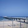 Steg am Timmendorfer Strand führt ins Meer bei klarem Himmel.