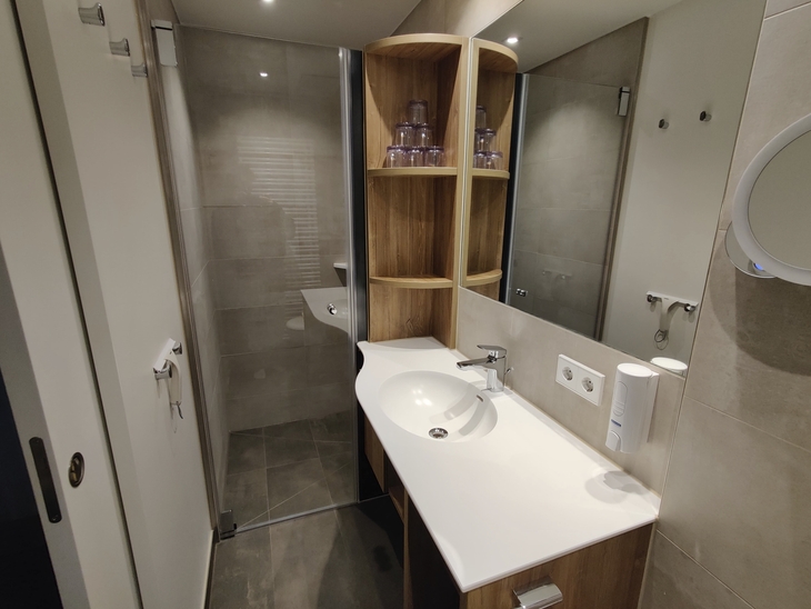 Modernes, renoviertes Badezimmer mit Dusche und Waschbecken.
