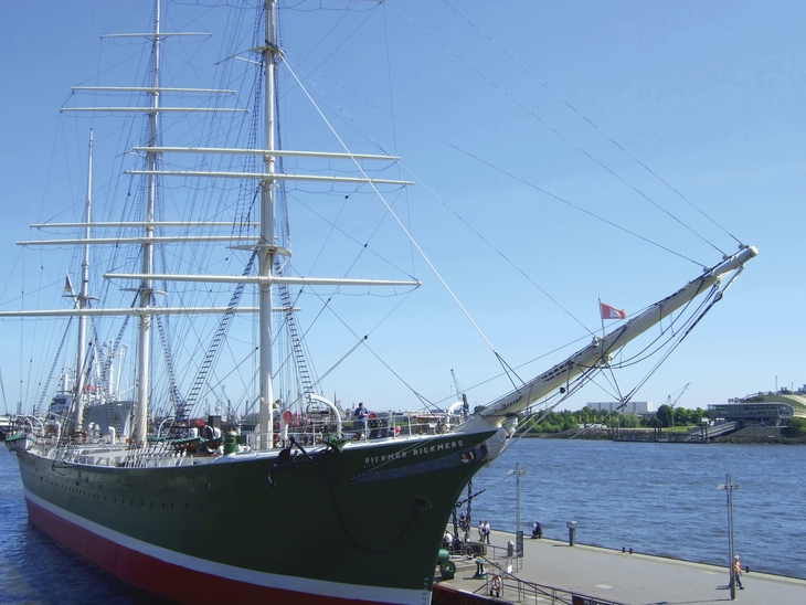 Großes Segelschiff im Hafen bei klarem Himmel.