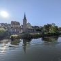 Turm und Gebäude reflektieren im Wasser bei Sonnenlicht in Karlstadt.